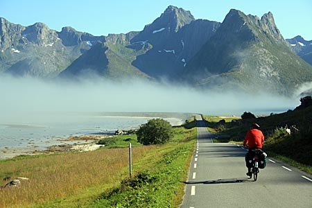 Norwegen - Lofoten - Überirdisch: Bucht am Grunnførfjorden im Norden von Austvågøy, durch die die Straße führt. Der Nebel erhebt sich wie ein Band über dem Strand und die Sonne kommt raus